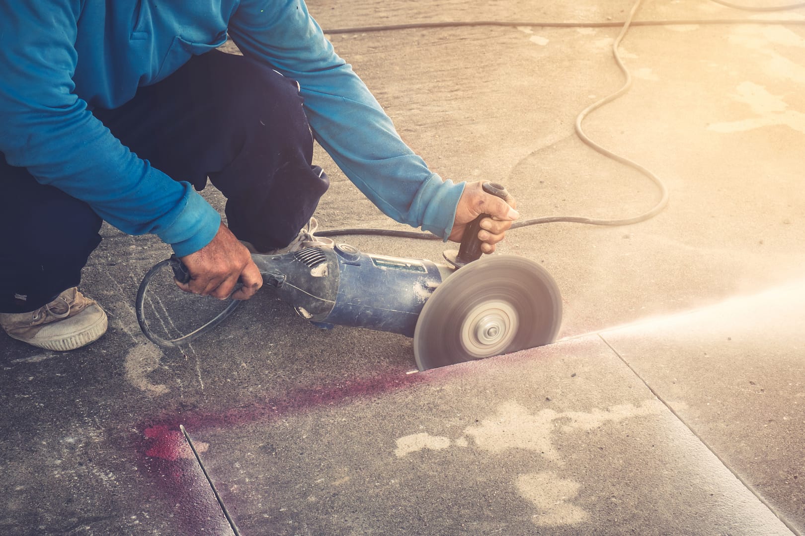 Worker using a handheld saw for precise concrete sawing in Halifax